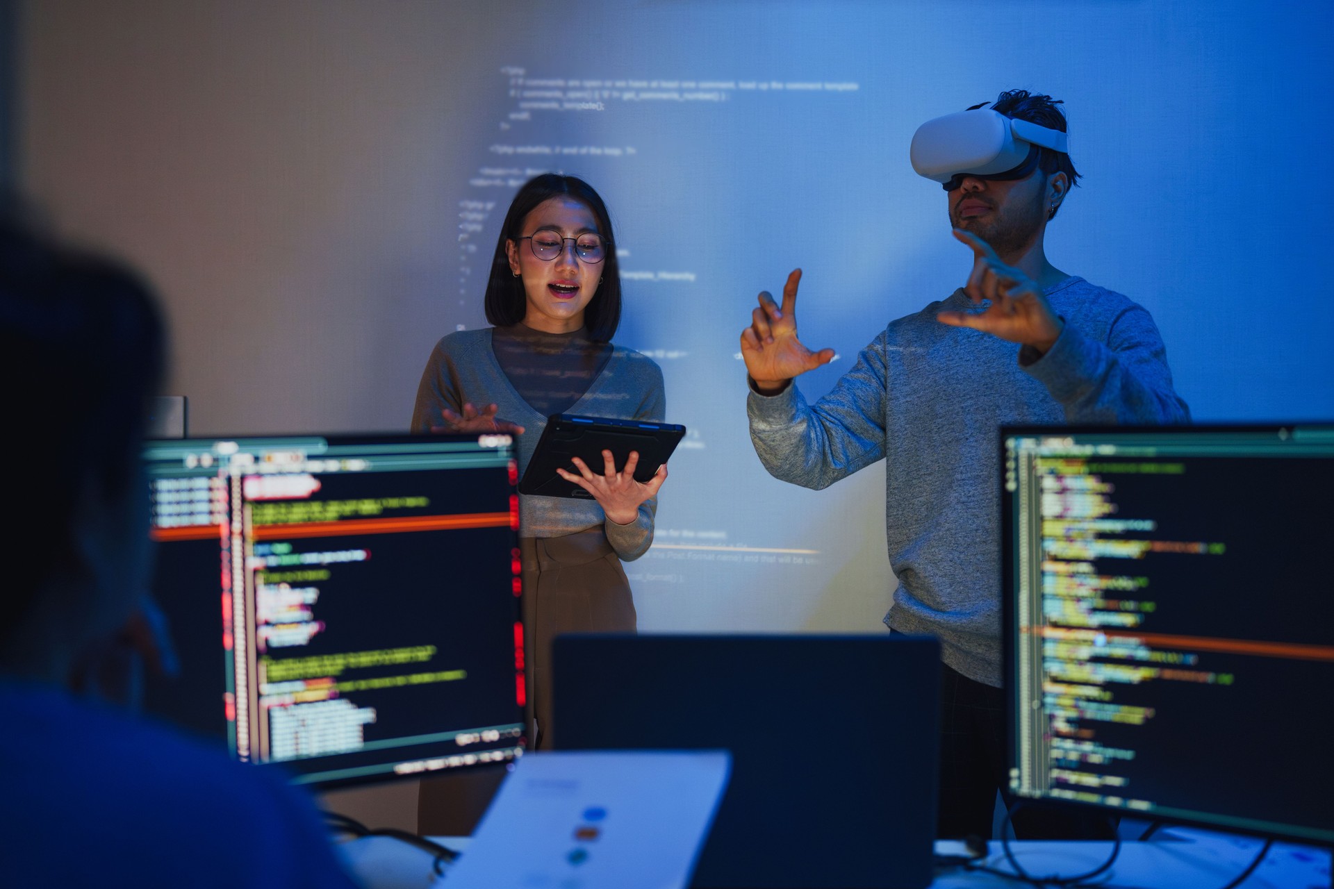 asian and Indian developer team brainstorming and presentation about virtual reality  with ai coding project at night in office